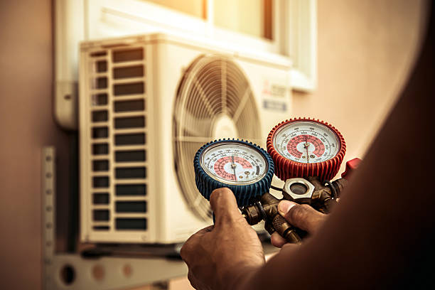 Professional Air Conditioning Service technician working in East Baldwin, ME